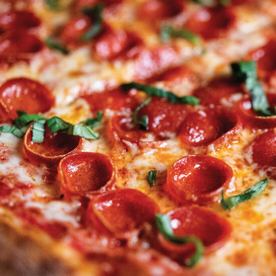 Close up of pizza with cup and char pepperoni