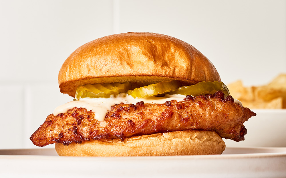 Close up of a crispy chicken sandwich topped with pickles