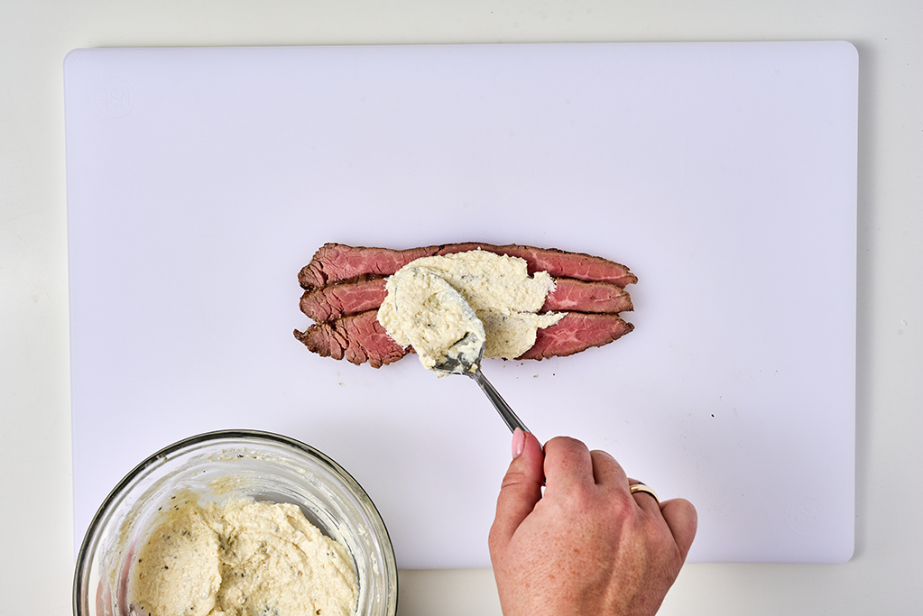 Spreading a mixture onto flank steak