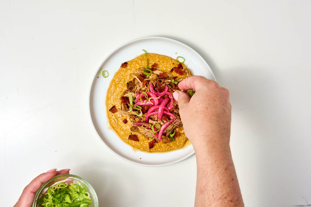 Garnishing dish with green onion slices